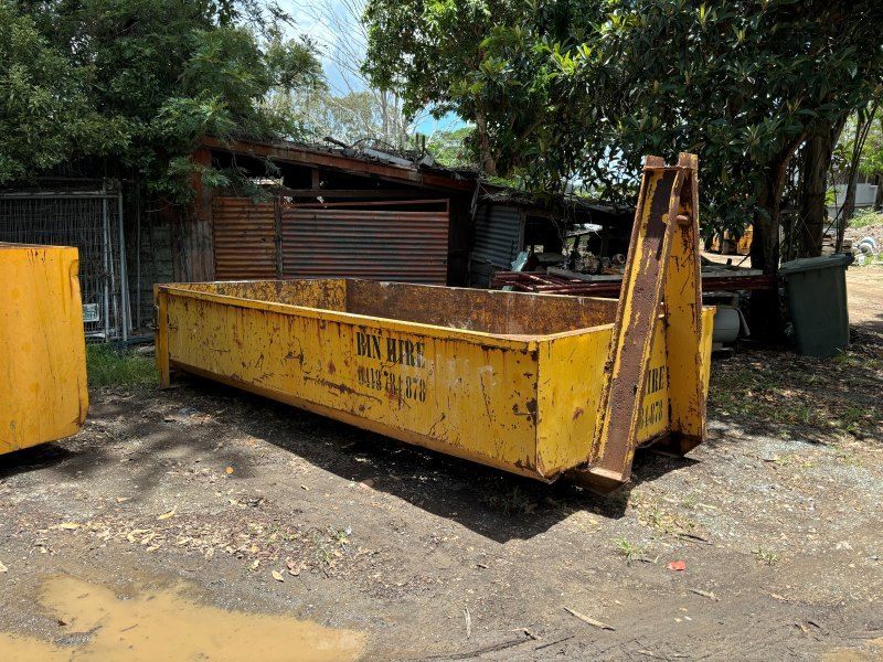 A Large Yellow Dumpster is Parked in a Dirt Lot — Bin Hire in Maryborough, QLD