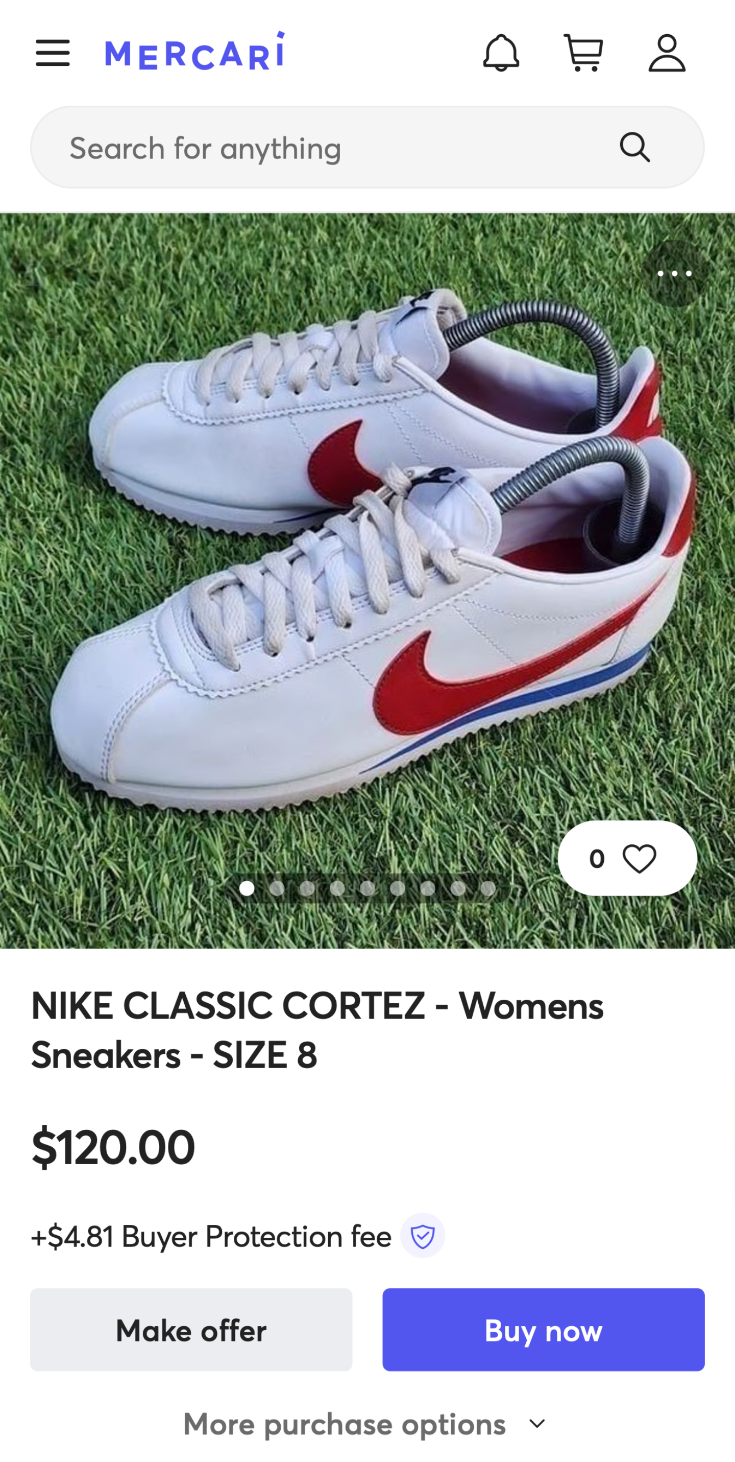 White Nike low-top sneakers with red swooshes displayed on a shopping app product page