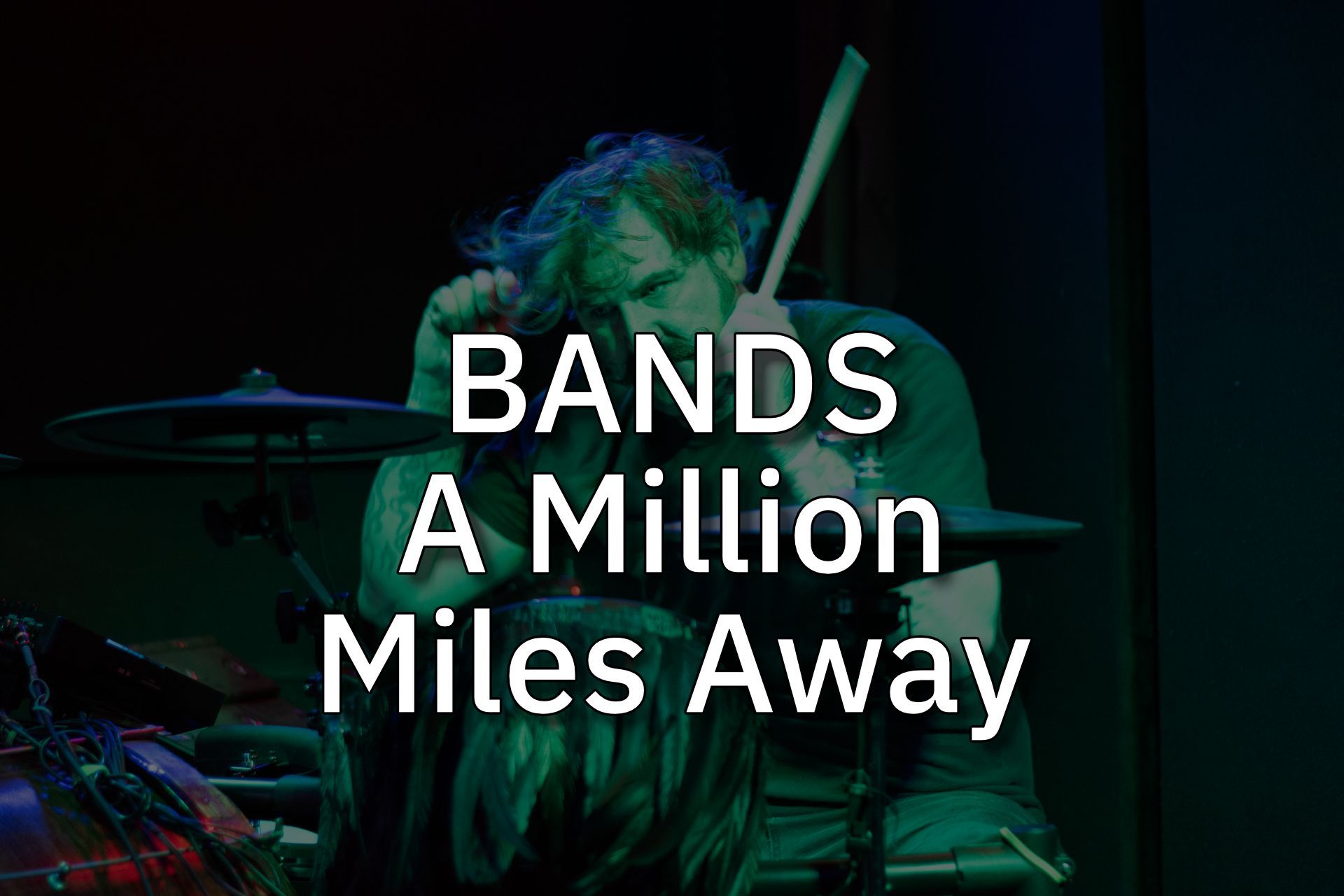 Band performing on a dark stage with neon lighting and the title “A Million Miles Away” overlaid