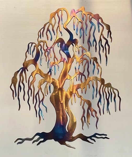 Colorful metal willow tree wall art on a beige background with a black base
