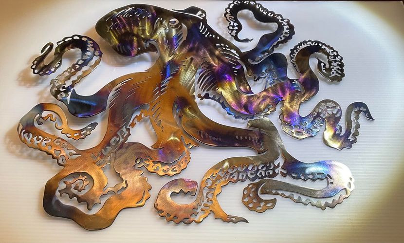 Colorful stylized octopus sculpture with purple, orange, and blue swirls on a light background