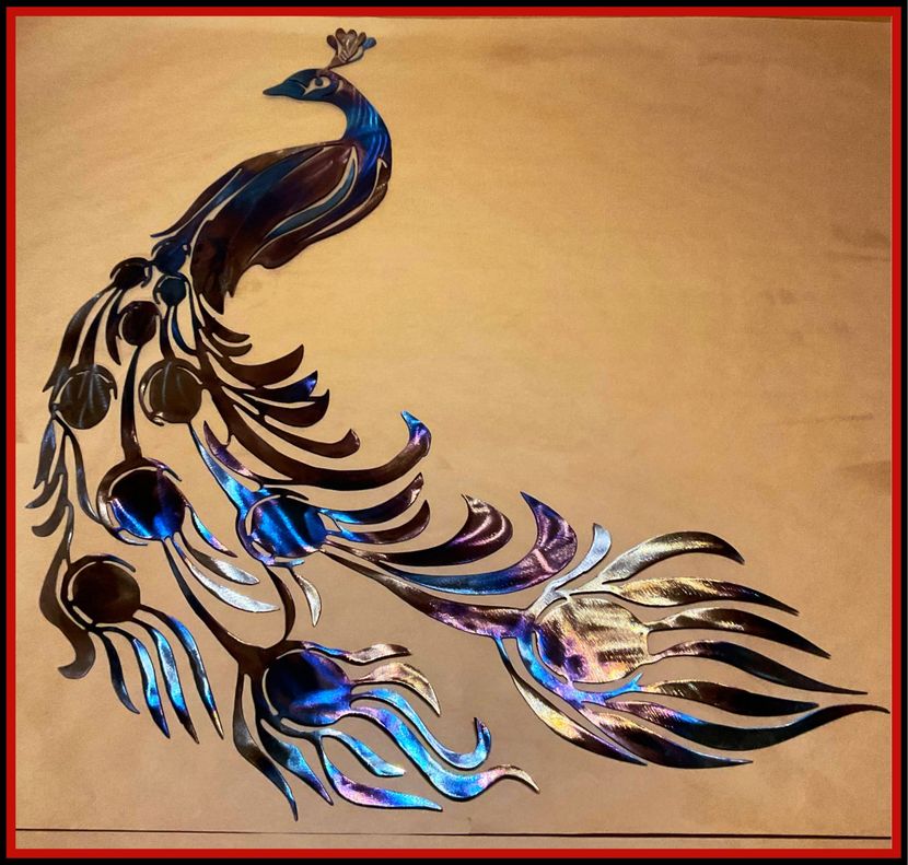 Decorative peacock artwork with iridescent blue, black, and silver feathers on a beige background