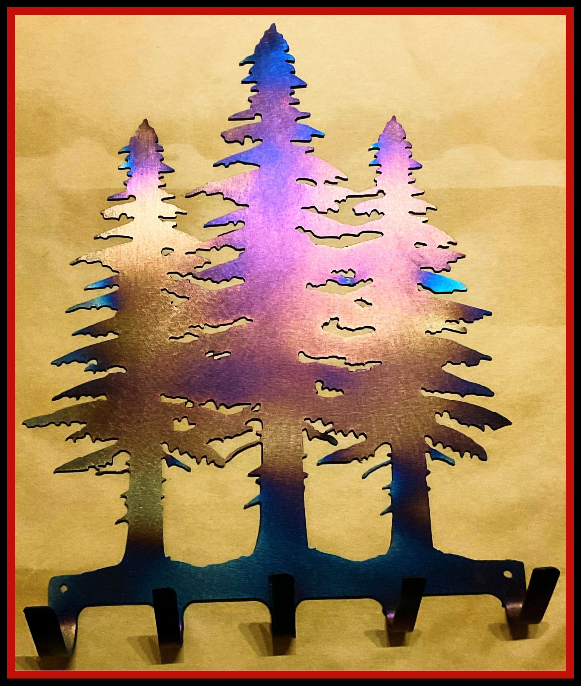 Colorful pine tree silhouette wall art in pink, blue, and gold tones on a beige background