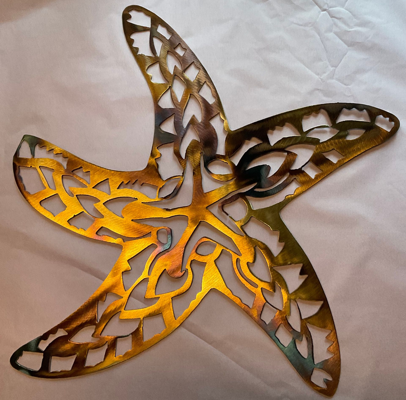 Five-pointed layered star ornament with yellow and brown cutout design on a light fabric background
