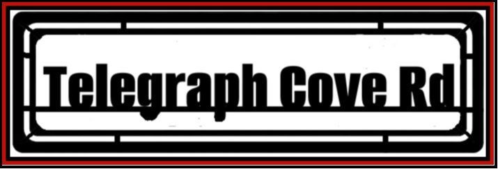 Black-and-white street sign reading “Telegraph Cove Rd”