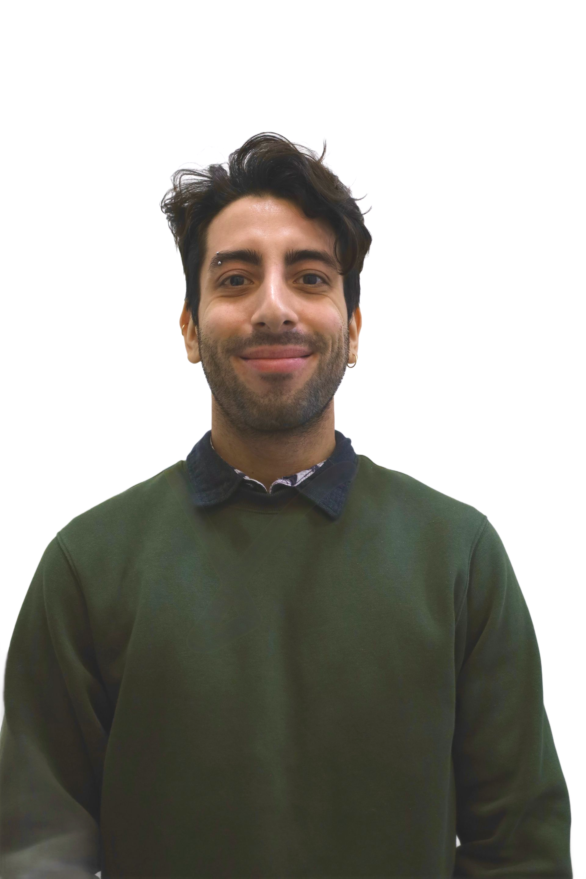 Man with dark hair and eyebrow piercing, smiling, wearing a green sweater and collared shirt.