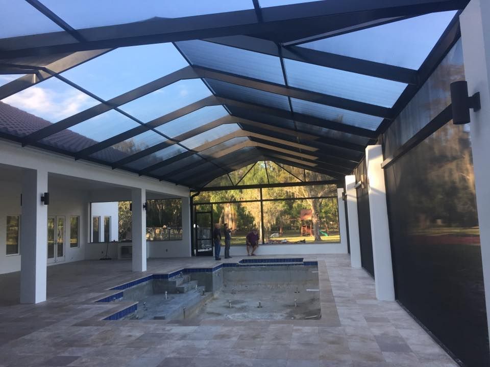 A swimming pool under a covered roof in a house