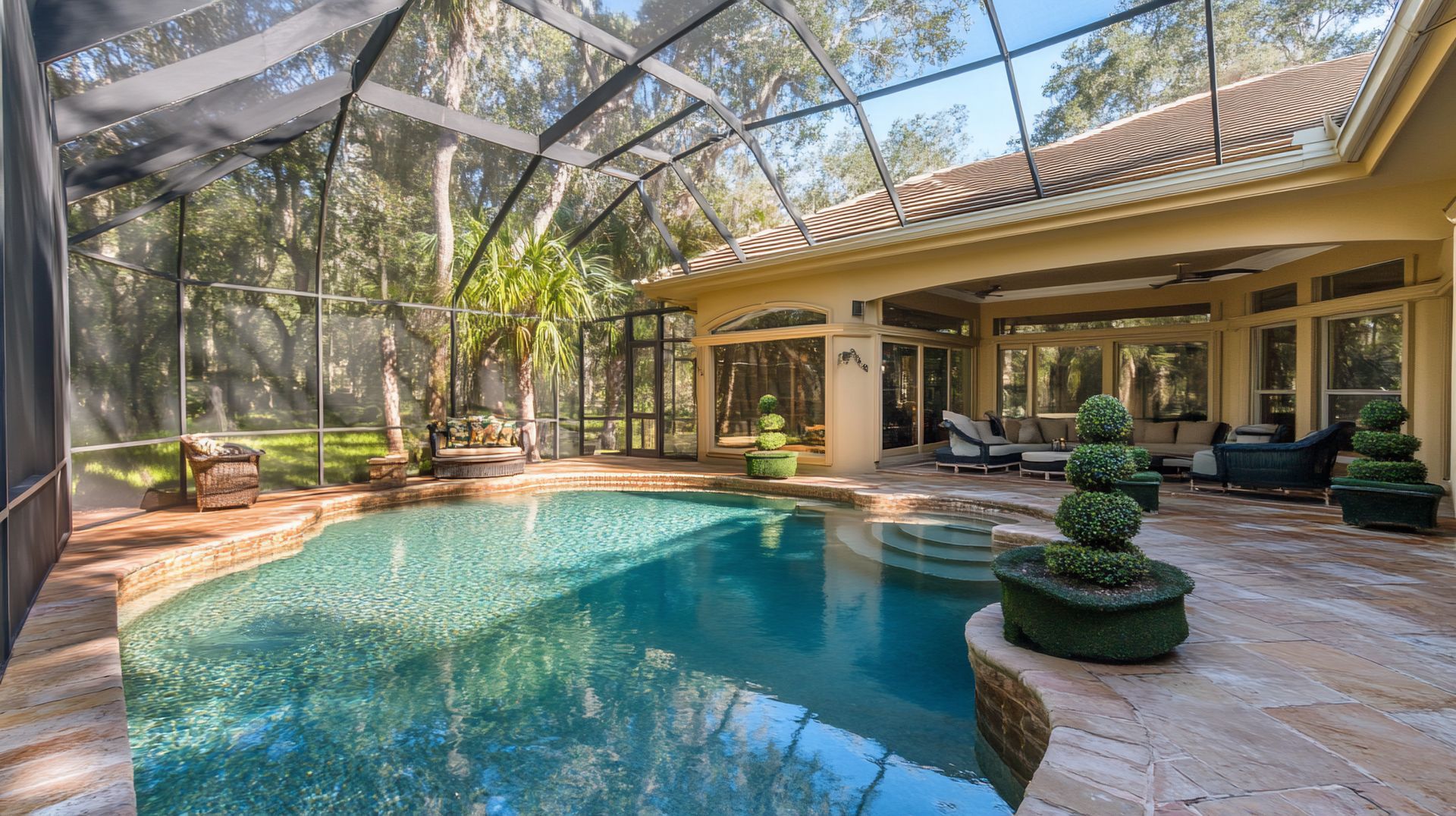 Screened patio enclosure surrounding luxury pool area with outdoor living space and views.