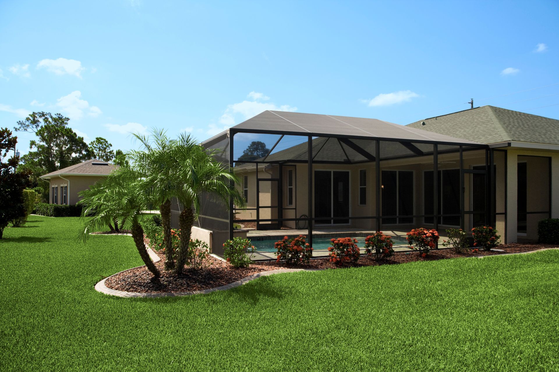 A house with a screened in porch and a pool in the backyard.