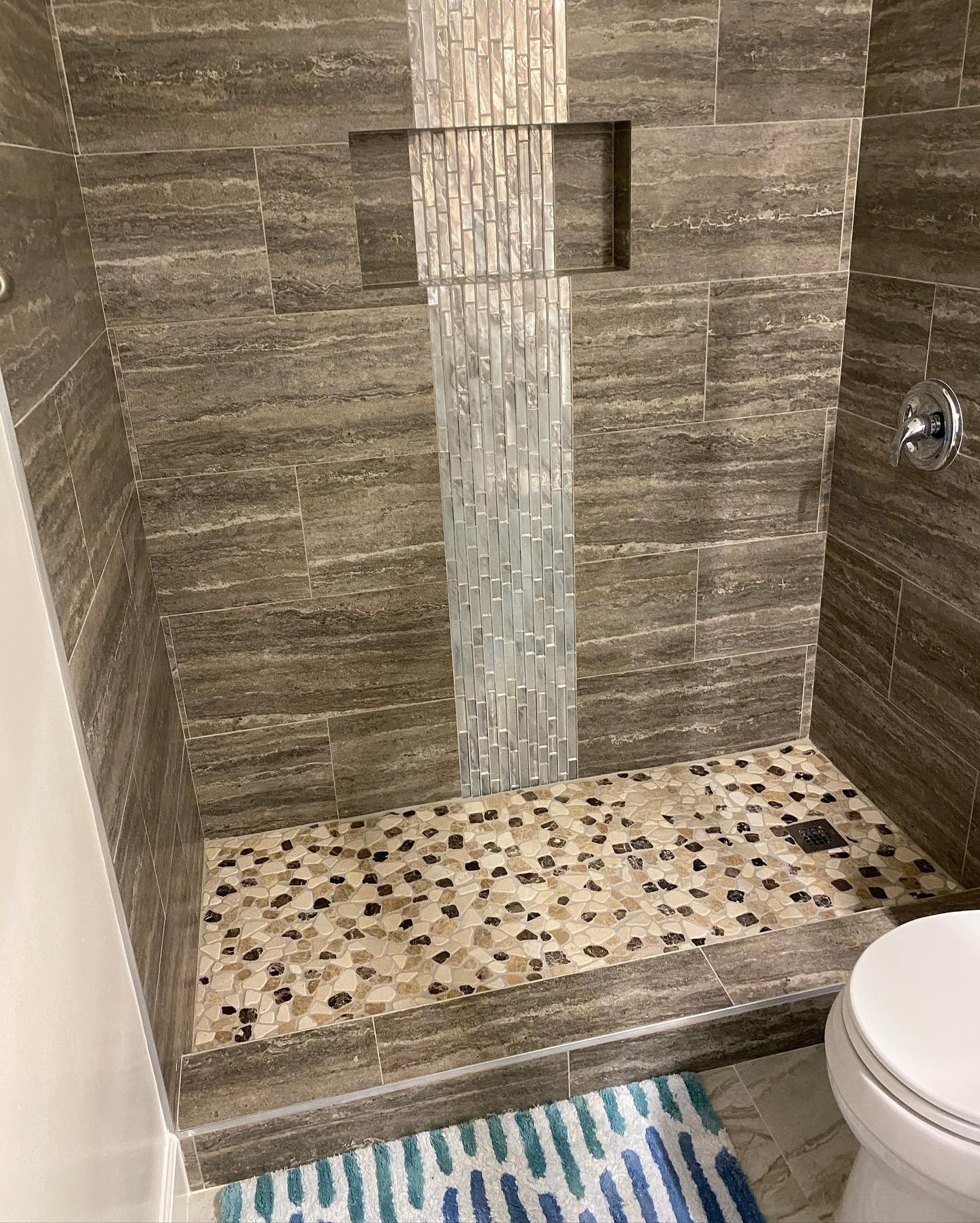 A bathroom with a walk in shower and a toilet.