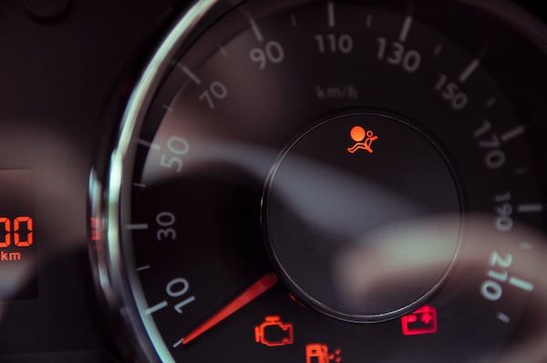 A close up of a speedometer with airbag warning | Lex Brodies
