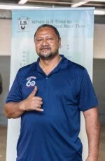 A man in a blue shirt is giving a thumbs up. | Lex Brodies 