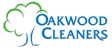 A logo for oakwood cleaners with a tree on it