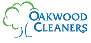 A logo for oakwood cleaners with a tree on it