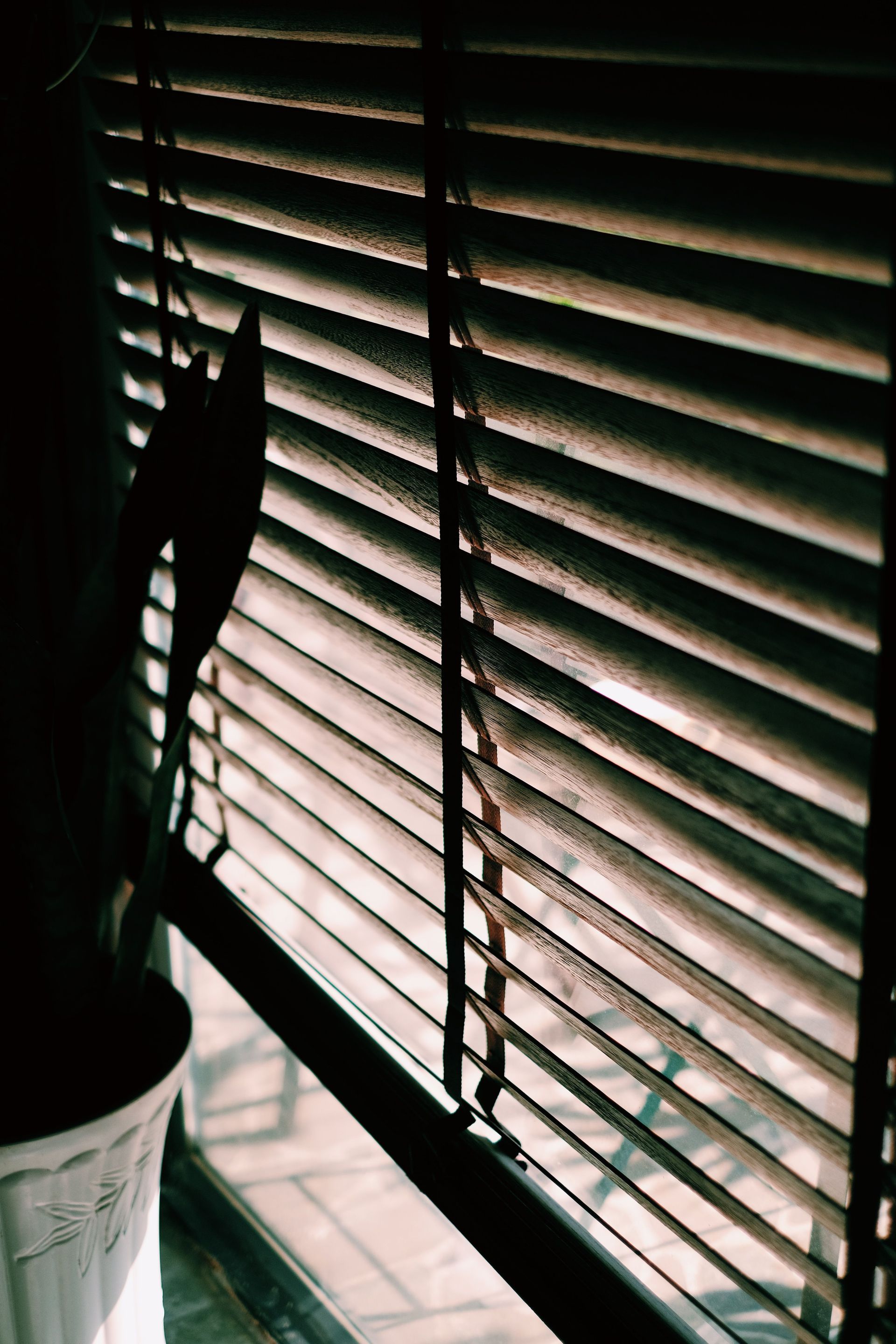 White curtains beside a black-framed window showing a snowy outdoor scene