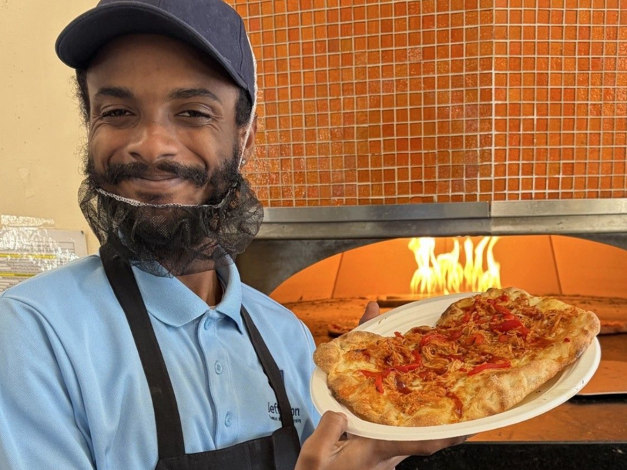 Person holding a flatbread pizza