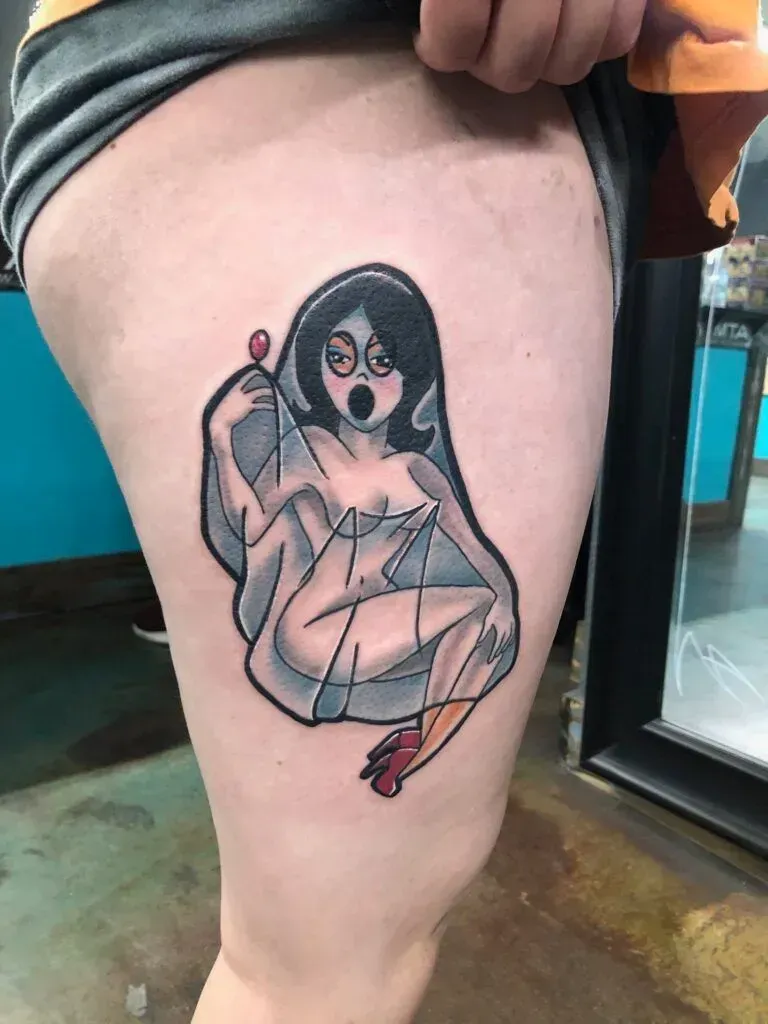 Tattoo of a surprised woman-ghost holding a broken mirror with a lollipop, on a thigh.