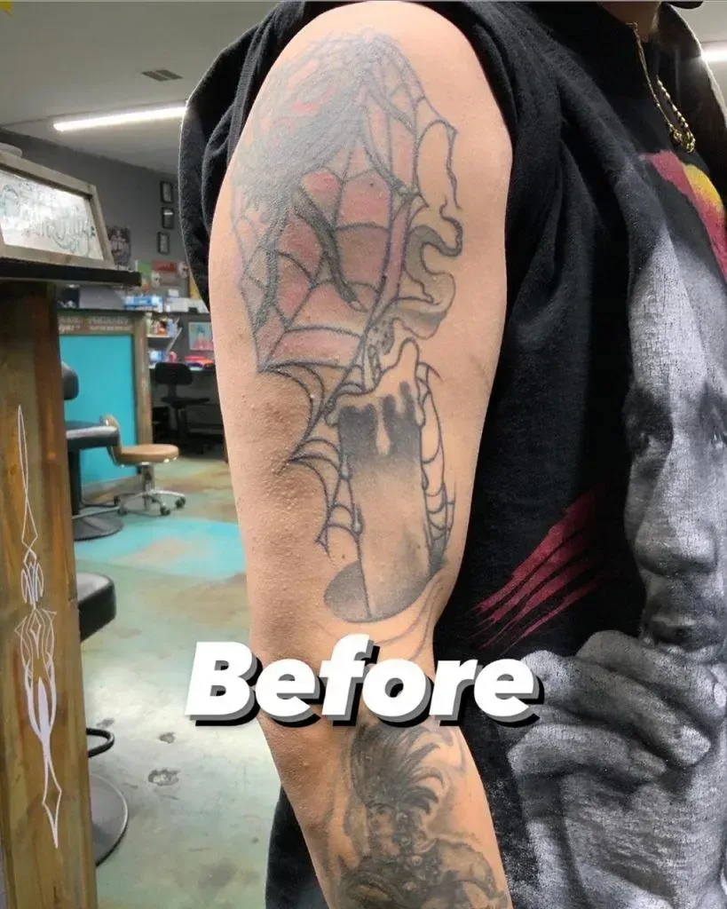 Arm with faded spiderweb and candle tattoo, labeled