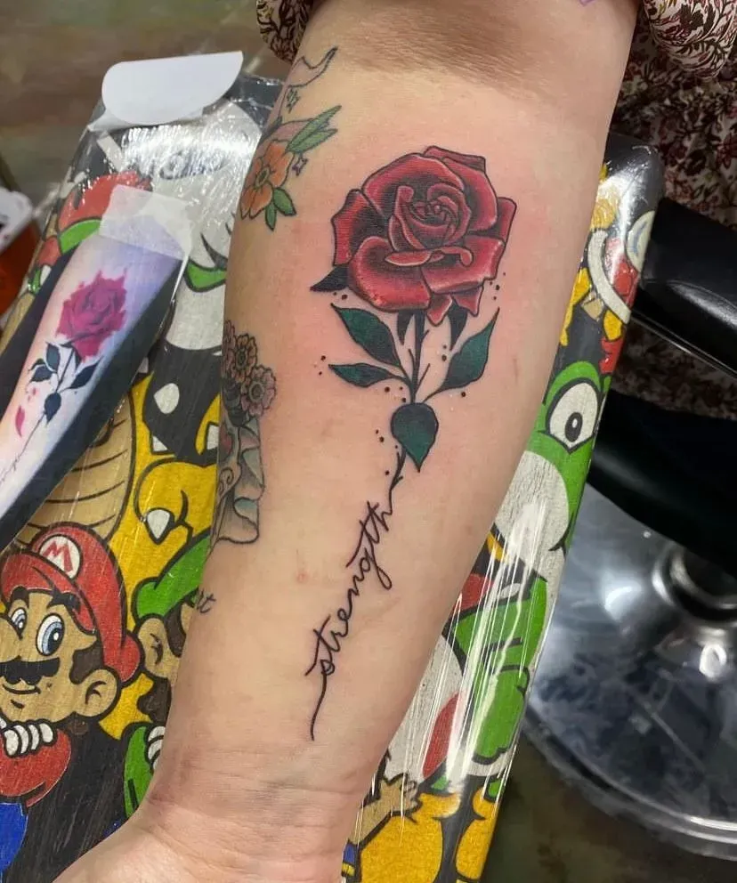 Tattoo of a red rose with the word