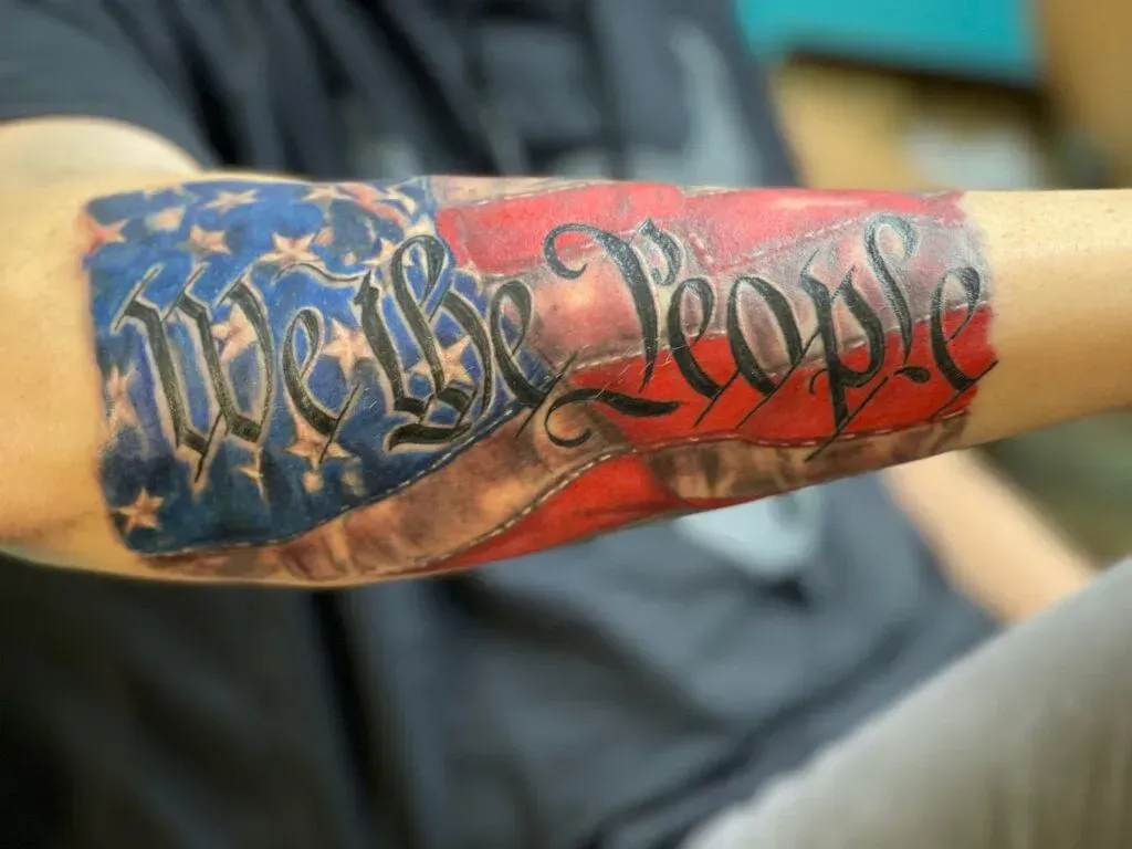 Tattoo of a faded American flag with
