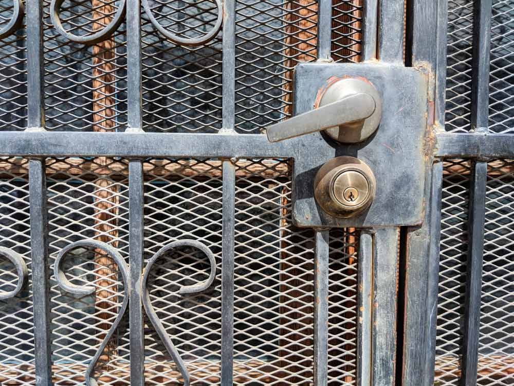 A Close Up Of A Rusty Wrought Iron Gate With A Handle — Smith Aluminium In Warners Bay, NSW