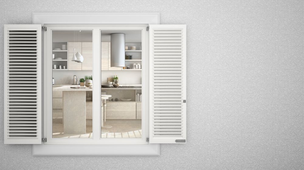 A Kitchen Is Visible Through A Window With White Shutters — Smith Aluminium In Shortland, NSW