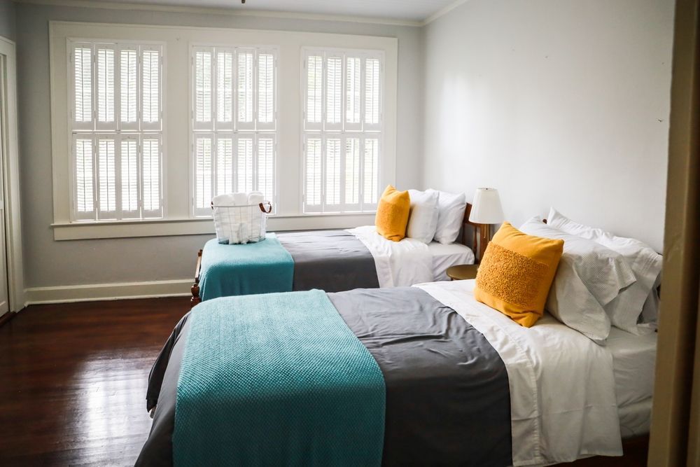 A Bedroom With Two Twin Beds And A Large Window — Smith Aluminium In Warners Bay, NSW