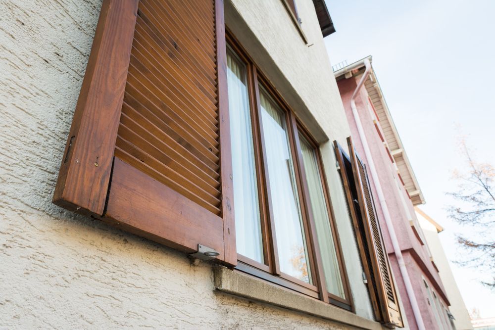 A Close Up Of A Window With Wooden Shutters — Smith Aluminium In New Lambton, NSW