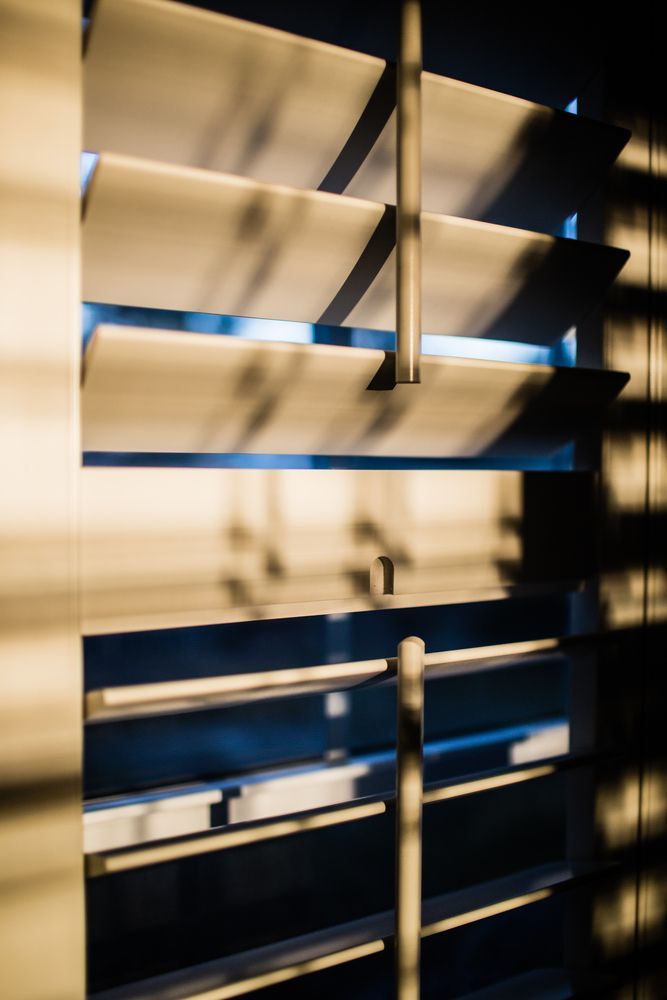 A Close Up Of A Window With Shutters On It — Smith Aluminium In Broadmeadow, NSW