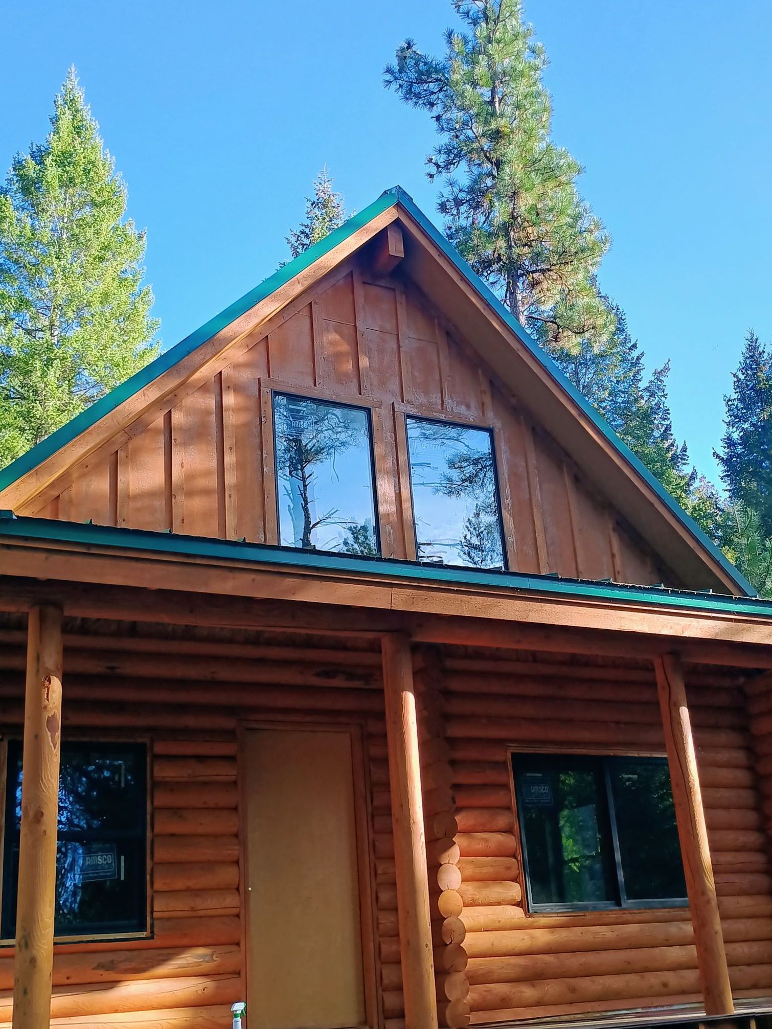 A small house with a porch and a satellite dish on the roof.