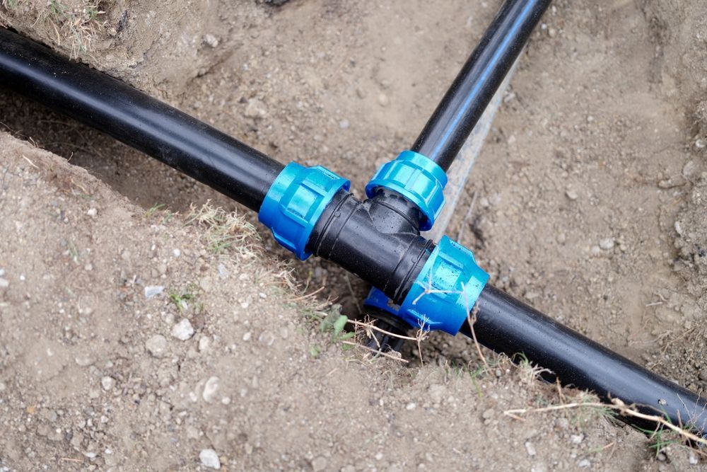 A Black Polyethylene Pipe Tee Fitting — GPE Plumbers In Kendall, NSW