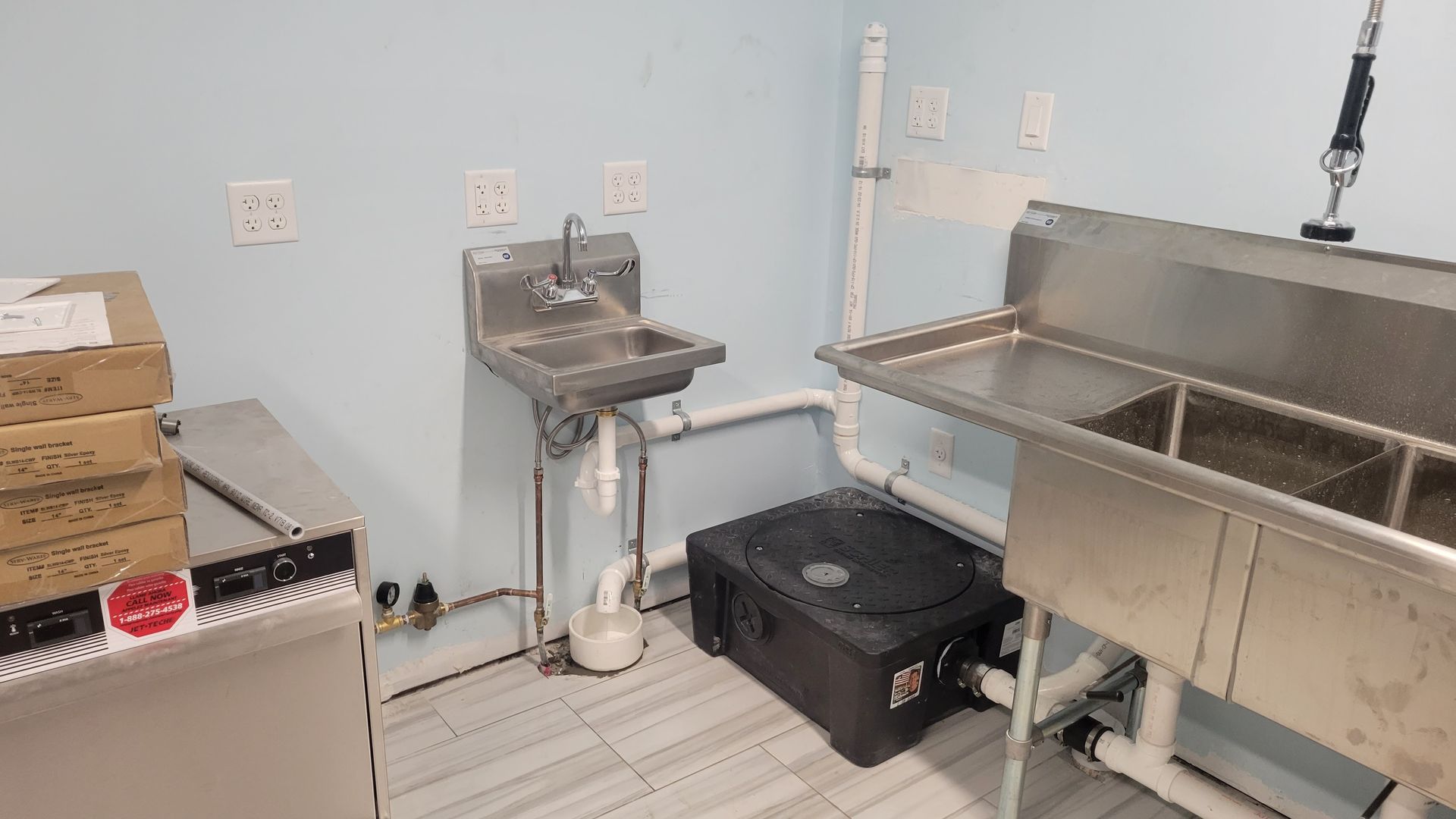 A kitchen with a sink and a dishwasher in it.