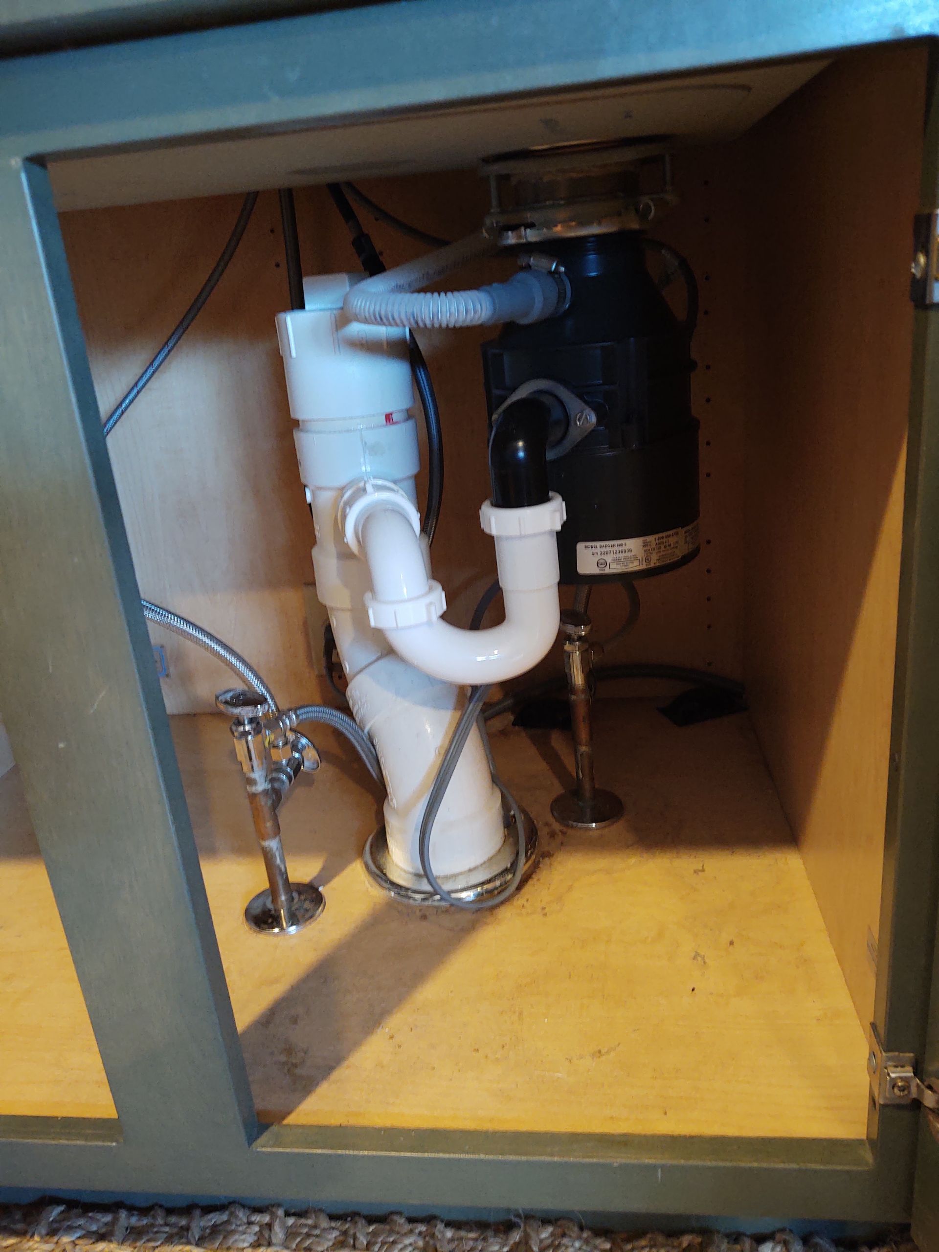 A sink with a garbage disposal underneath it.