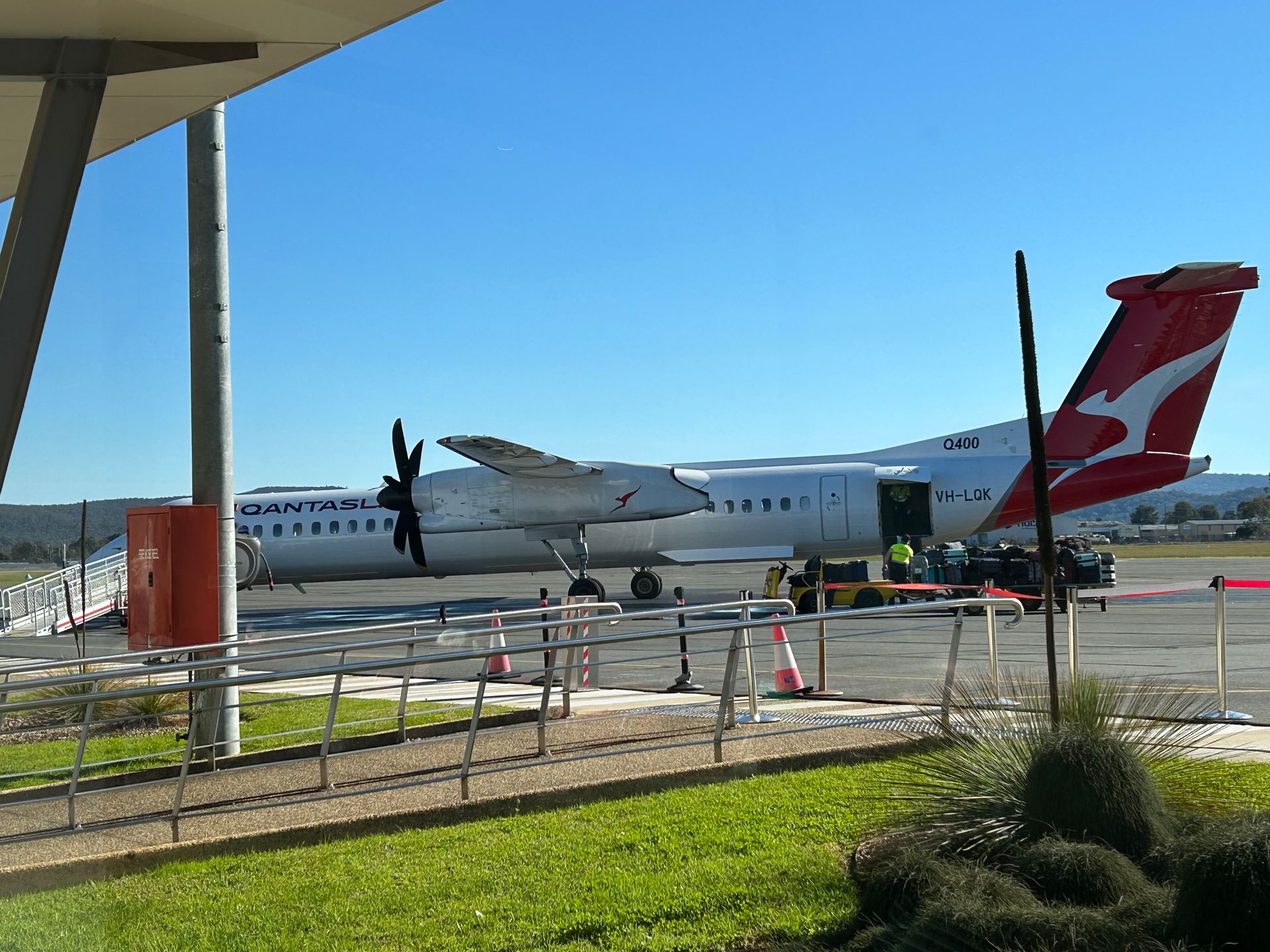 A qantas plane is parked on the tarmac at an airport