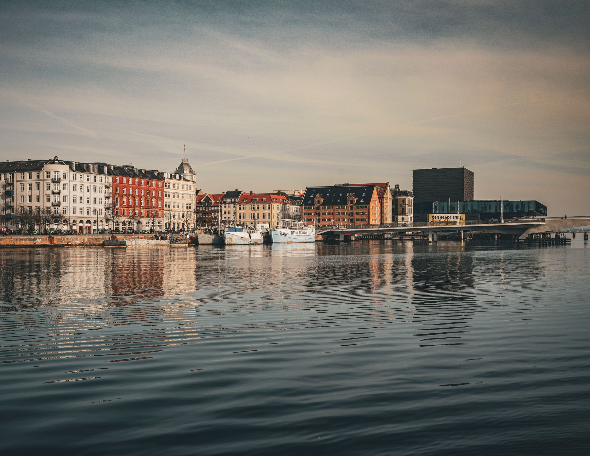 Copenhagen waterfront with buildings reflected in calm water