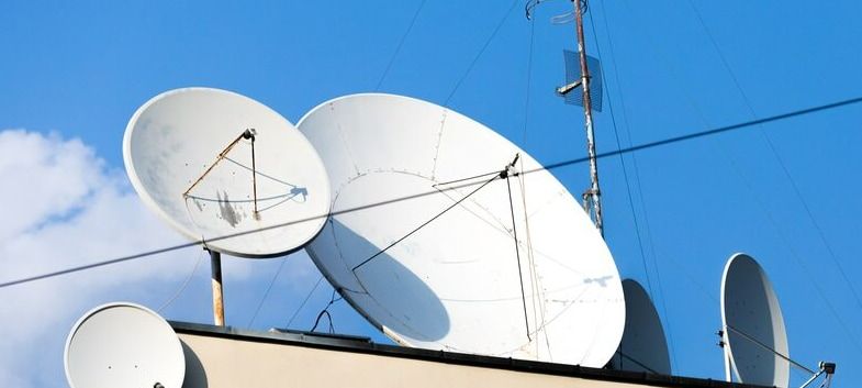 A Bunch Of Satellite Dishes Are Sitting On Top Of A Building — Outback Internet & Comms In Ciccone, NT