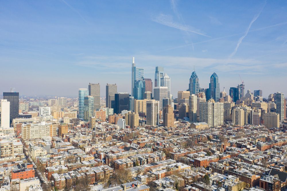 An aerial view of a city skyline on a sunny day.