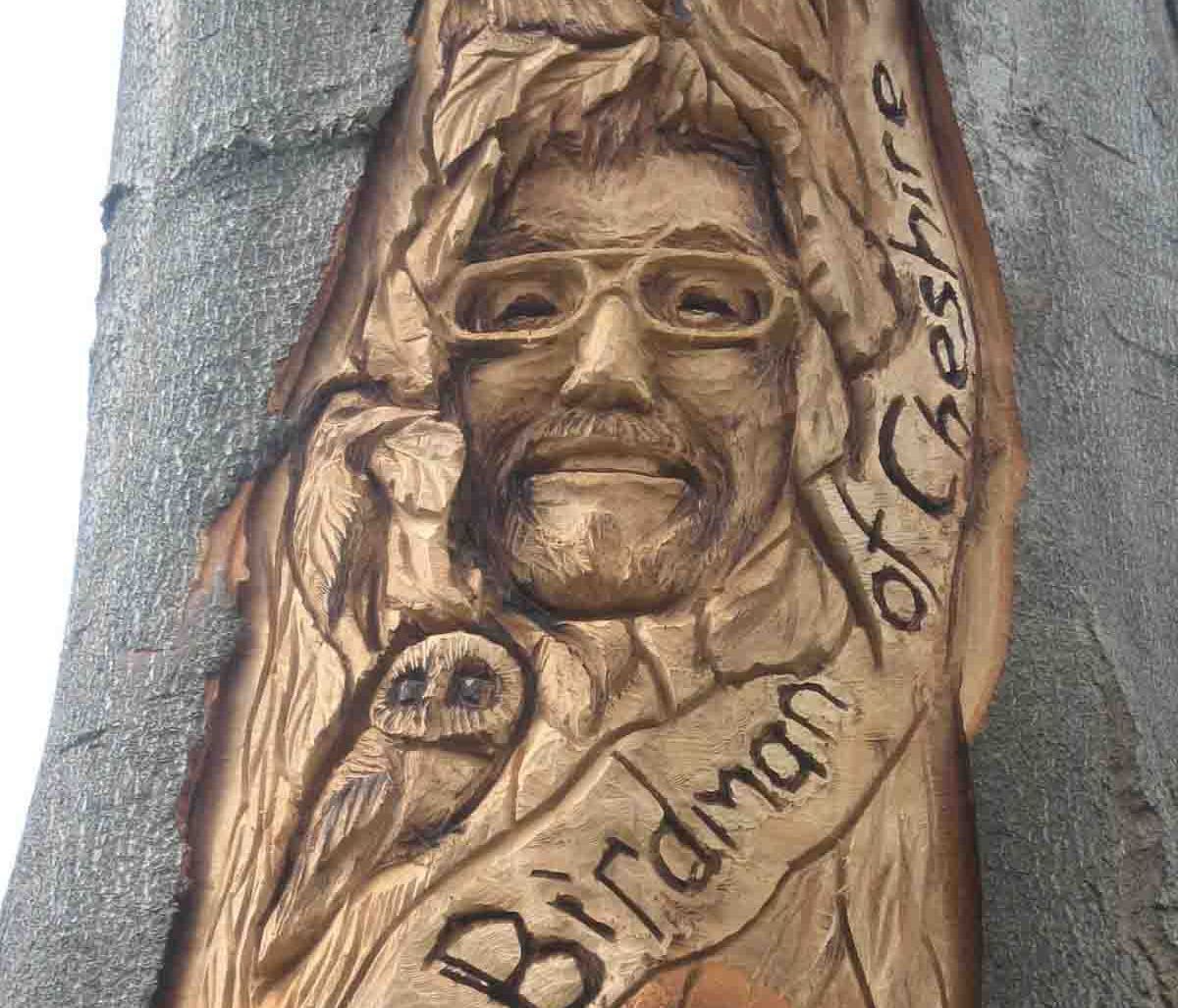 Wood carving of a man with glasses,