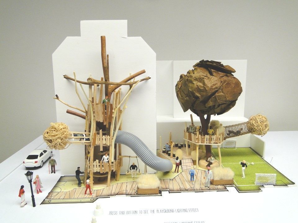Model playground with tree structures, slide, and miniature figures.
