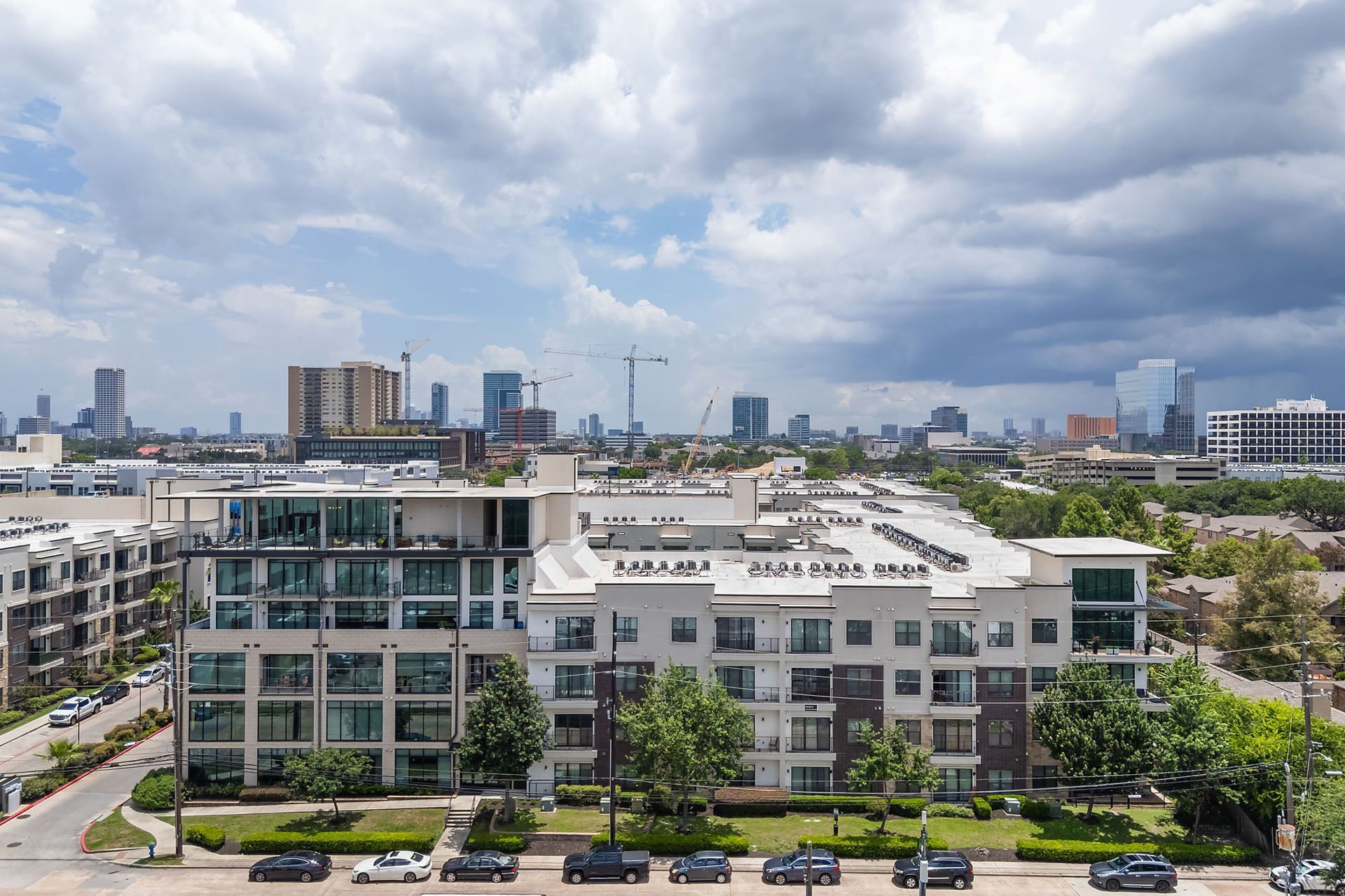 Modern office buildings with a city skyline under cloudy skies