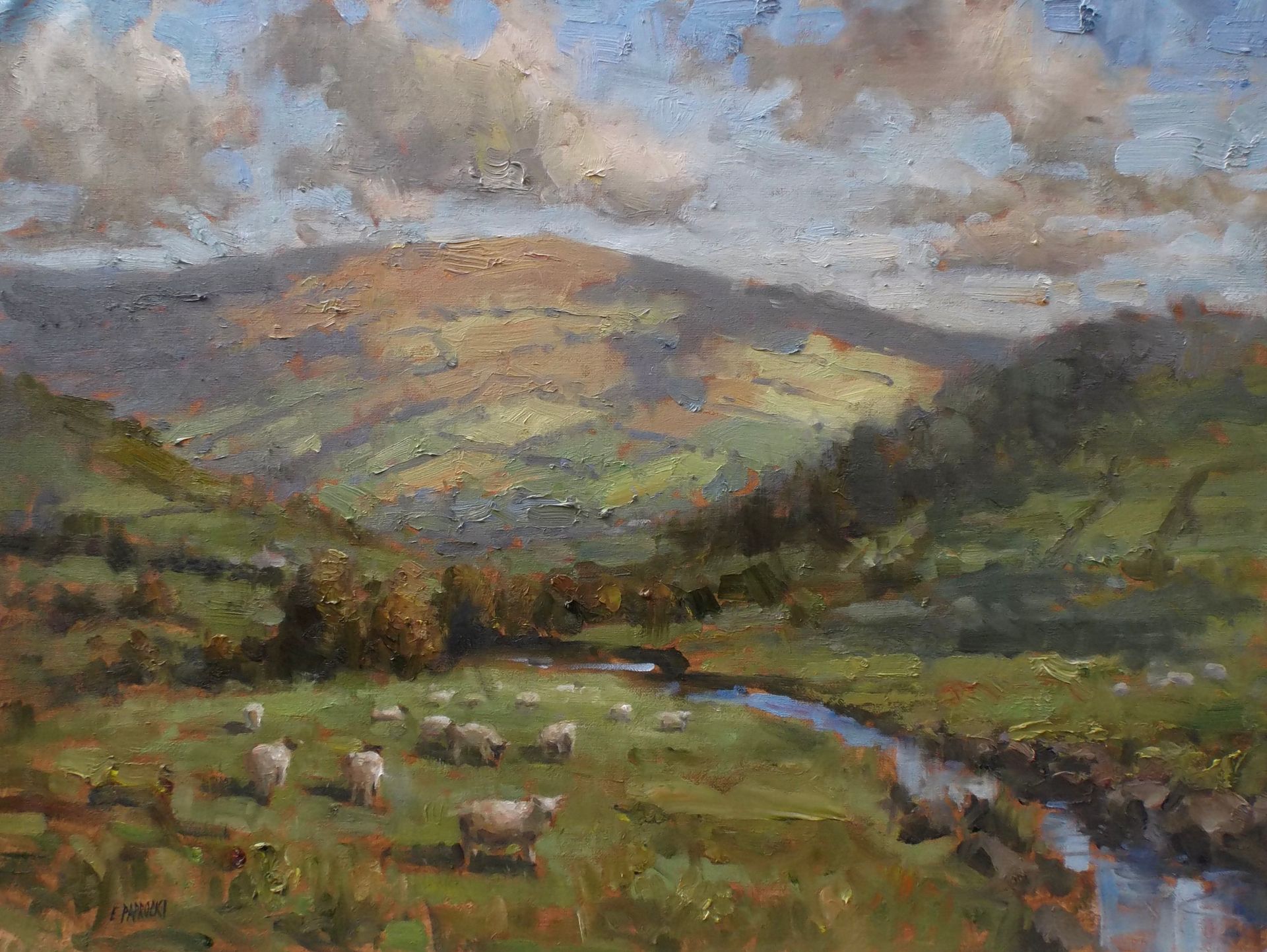 A painting of sheep grazing in a field with mountains in the background.