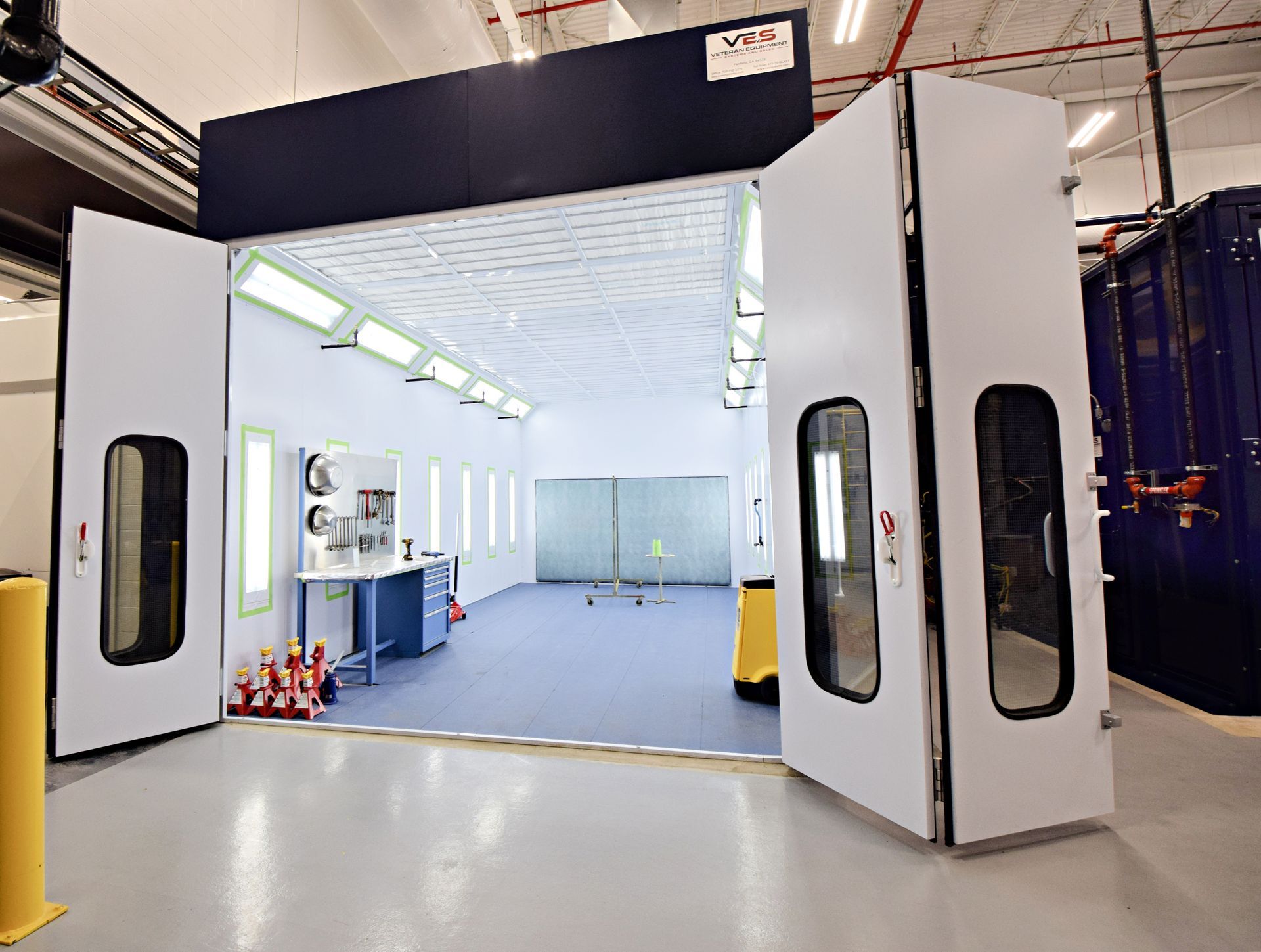 VES white paint booth interior with bright lighting, filtration, and operator access doors