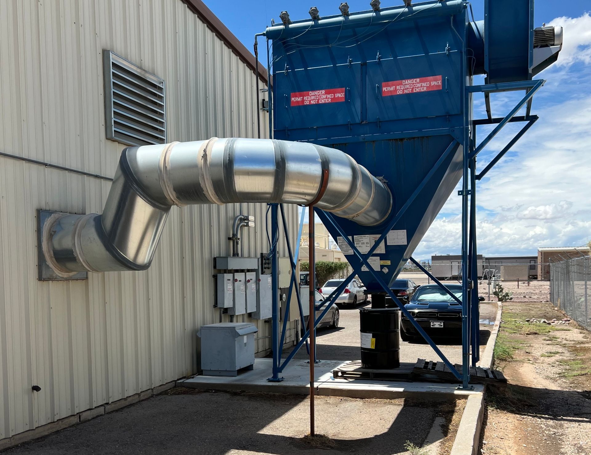 Blue VES dust collector installed on the outside of a building