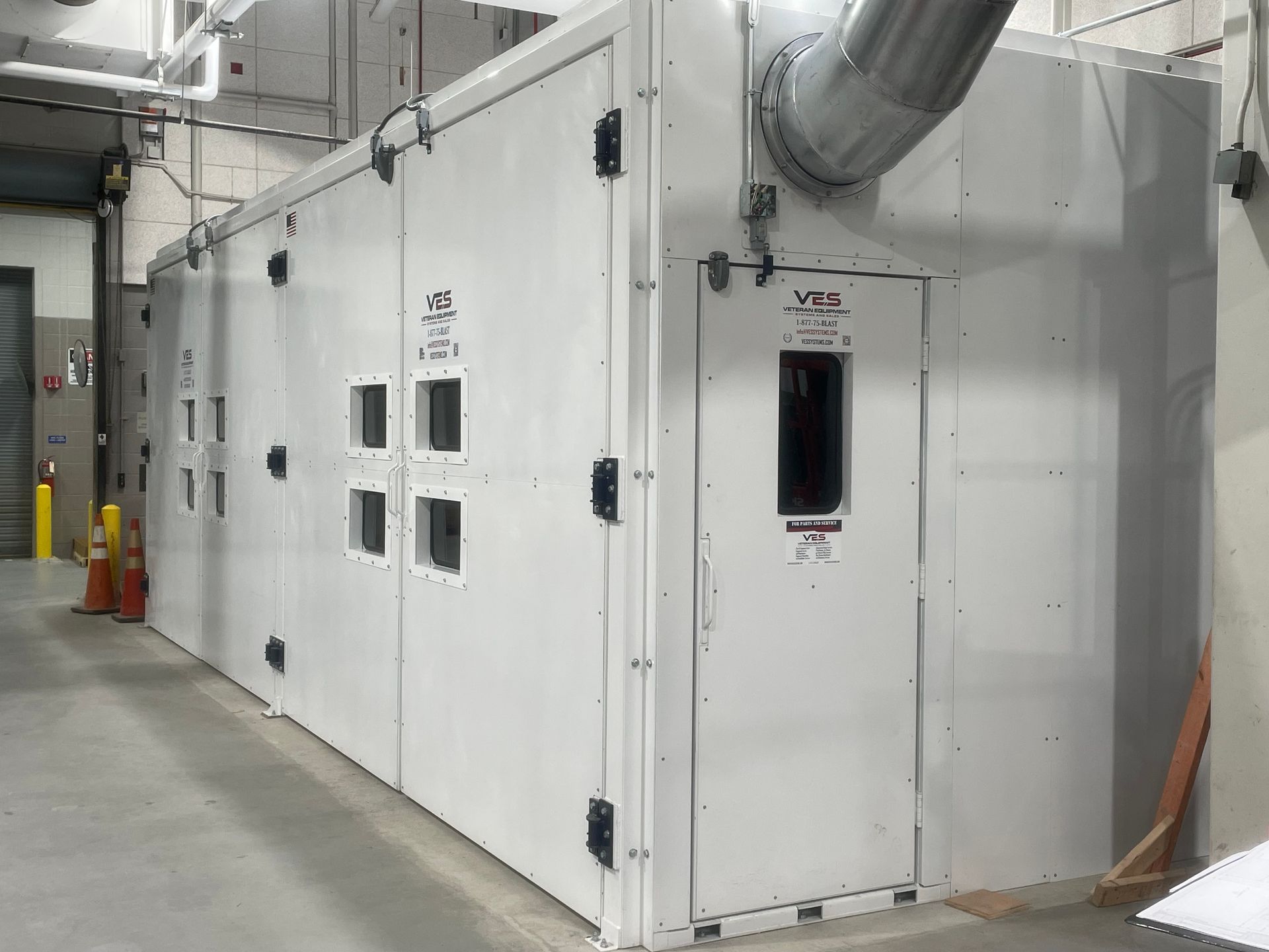 White industrial blast enclosure.