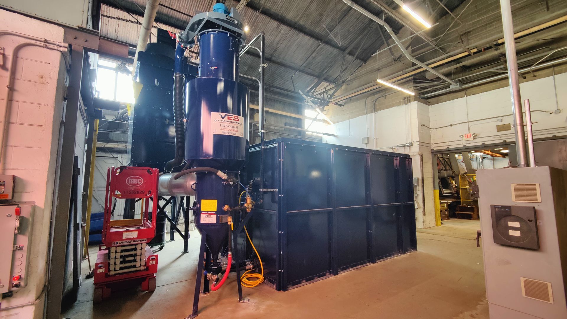 VES industrial blast enclosure and dust collection system installed inside a facility.