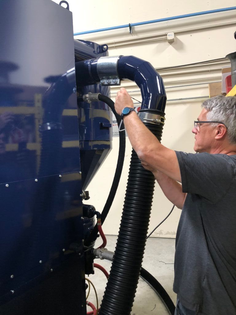 Technician servicing VES blast equipment.