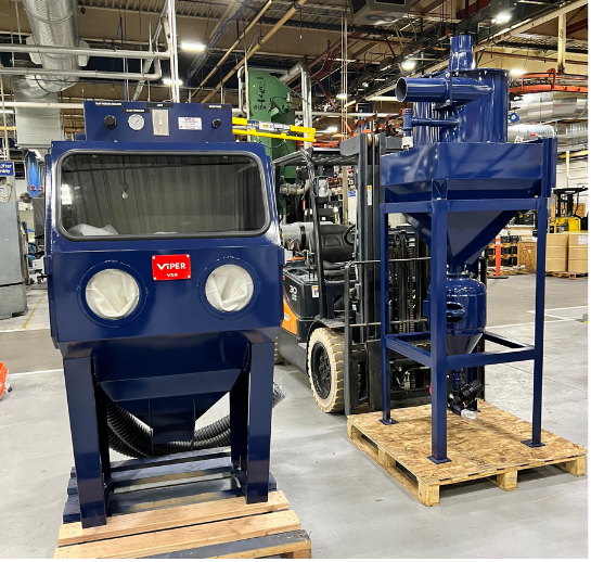 VES Viper Series compact blast cabinet and dust collector system positioned on pallets in an industrial facility