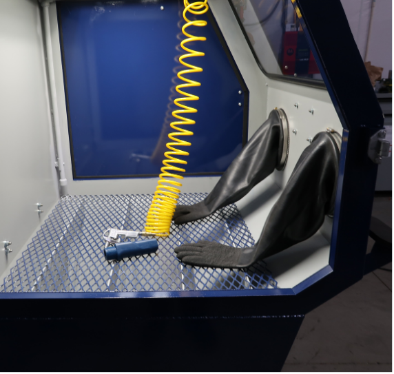 Interior view of VES Viper Series blast cabinet showing gloves, work surface, viewing window, and air blowdown hose