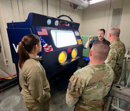 VES blast cabinet system being demonstrated to military personnel in an equipment training setting