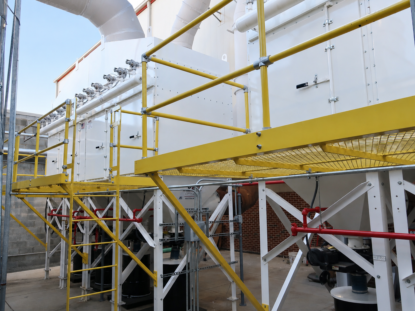Multiple white outdoor VES dust collectors with yellow railings and platforms